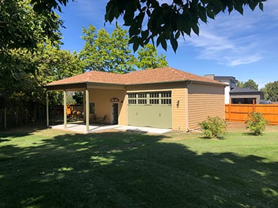 Custom Detached Garage - 40x26 with 14x20 cover. 12' tall walls, lap siding, 16x10 overhead door, hip roof, 4/12 pitch, 12" overhangs