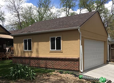 2 Car Detached Custom Built Garage for Denver Homes - 20x20, gable roof, staccato siding with brick wainscot, 6/12 pitch, 6" overhangs on two sides, 0" overhangs on gable ends, Owen's Corning dimensional roof